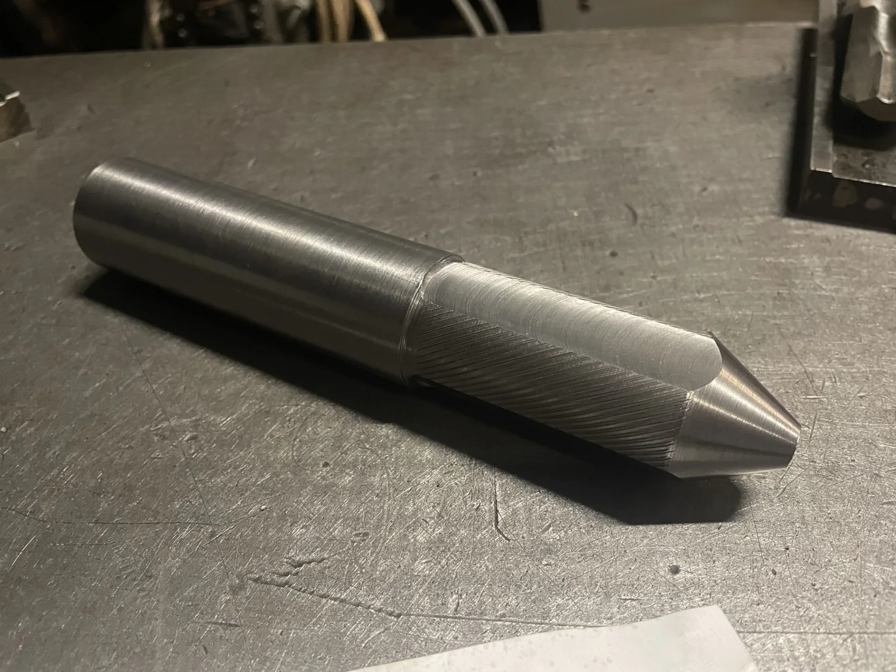Machined metal component on a workbench