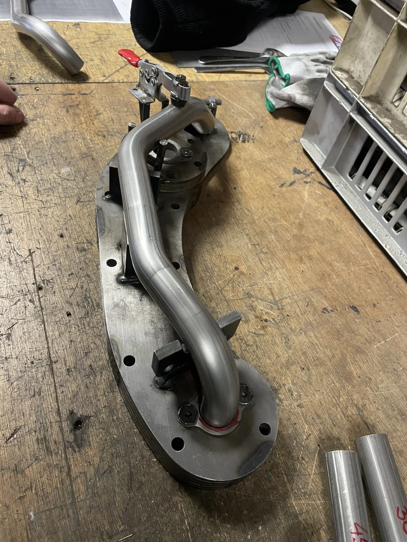Tubular fabricated component held in a workshop jig
